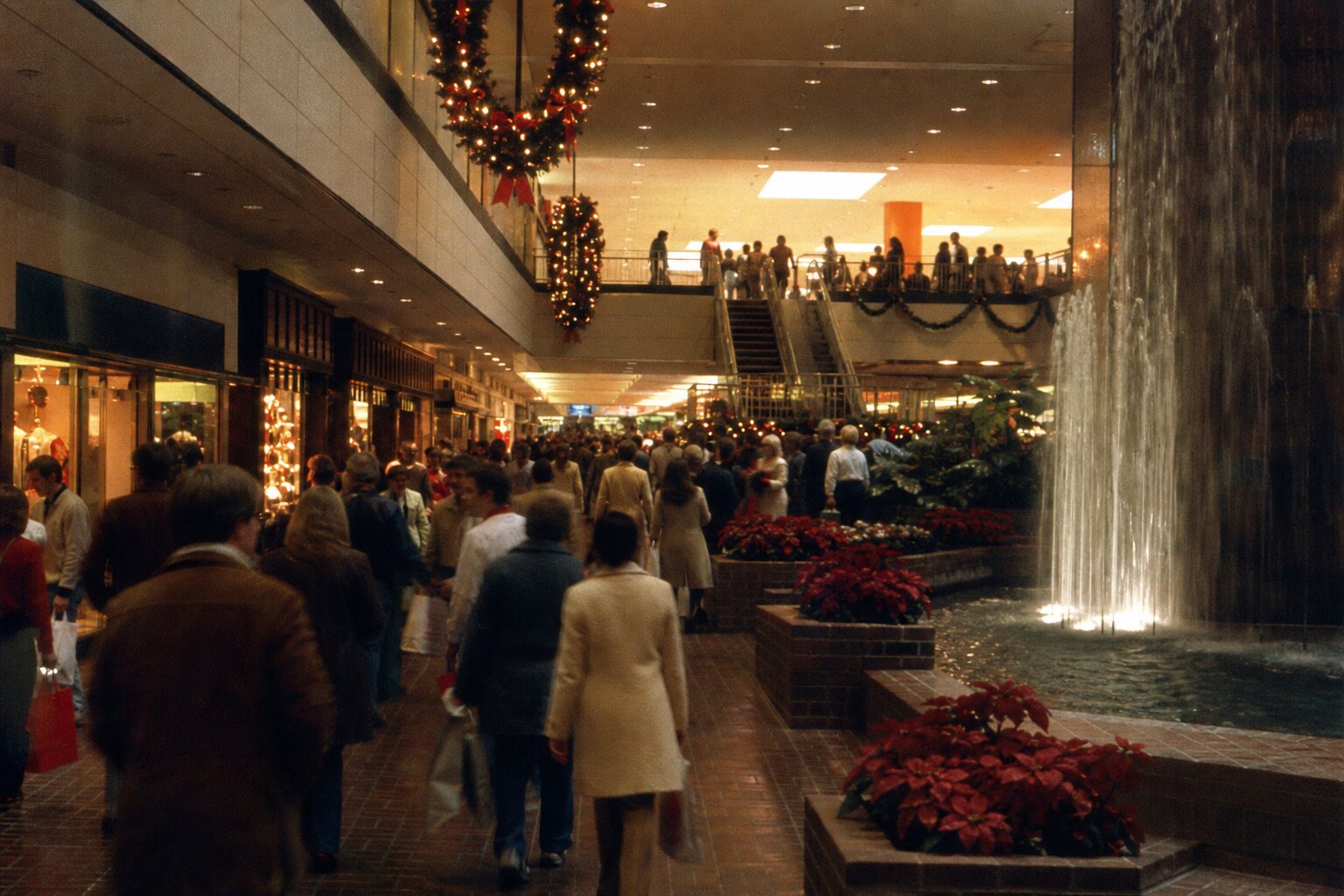 A mid-1970s shopping mall concourse with holiday decorations evokes Seminary South before the Fort Worth Missing Trio vanished.
