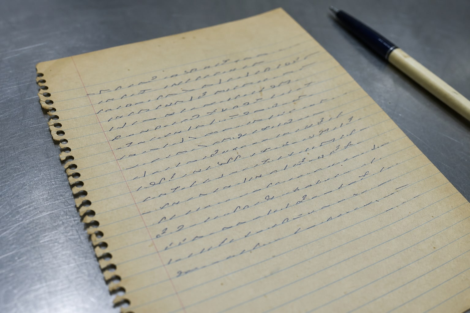 A lined school notebook page under harsh light, representing the dictated note in the Freeway Phantom case.