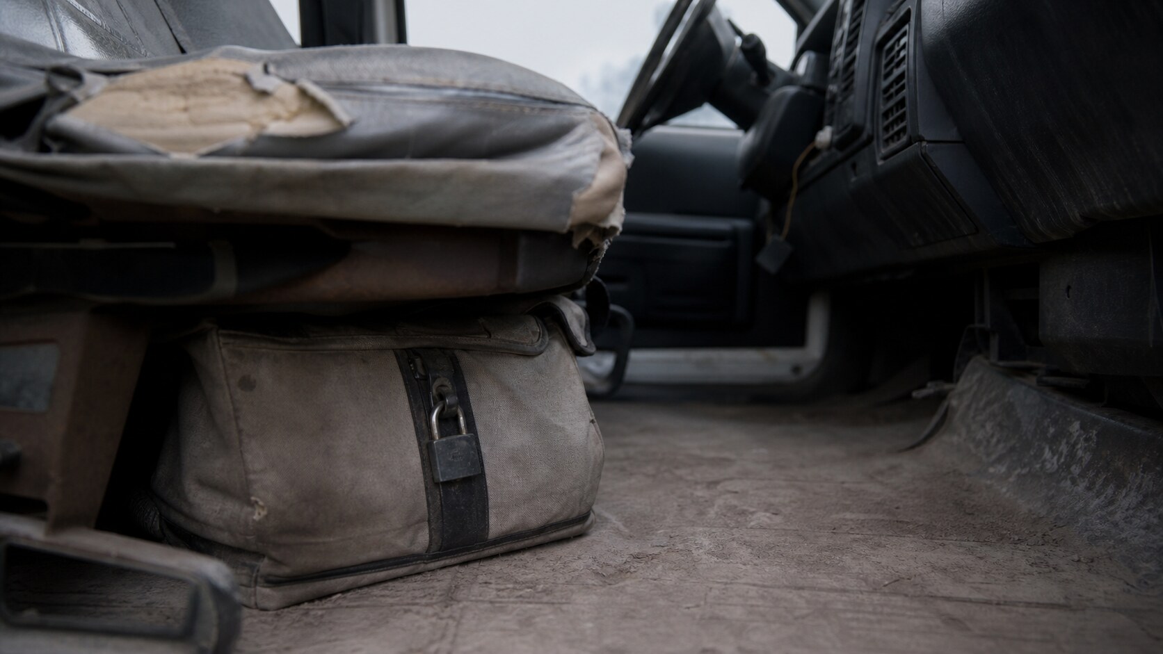 A locked bag under a pickup truck seat evokes the reported cash found in the Jamison family's abandoned vehicle.