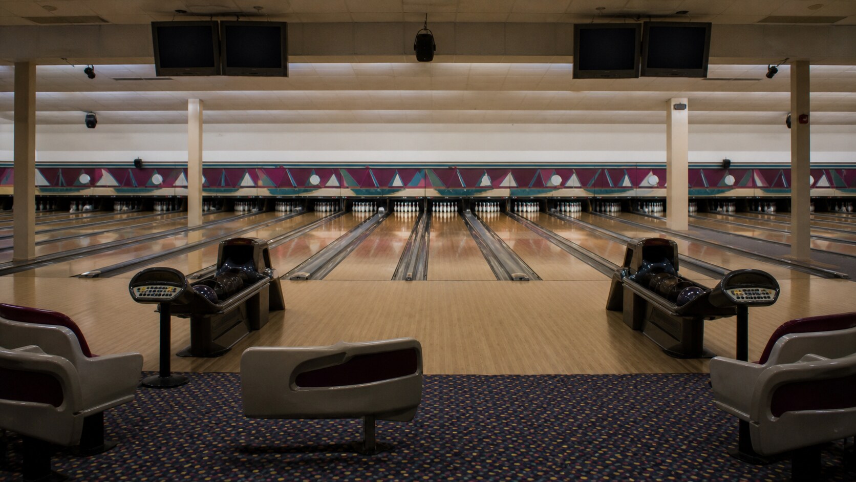 Empty bowling lanes before opening recreate the ordinary community setting of the Las Cruces Bowling Alley Massacre.