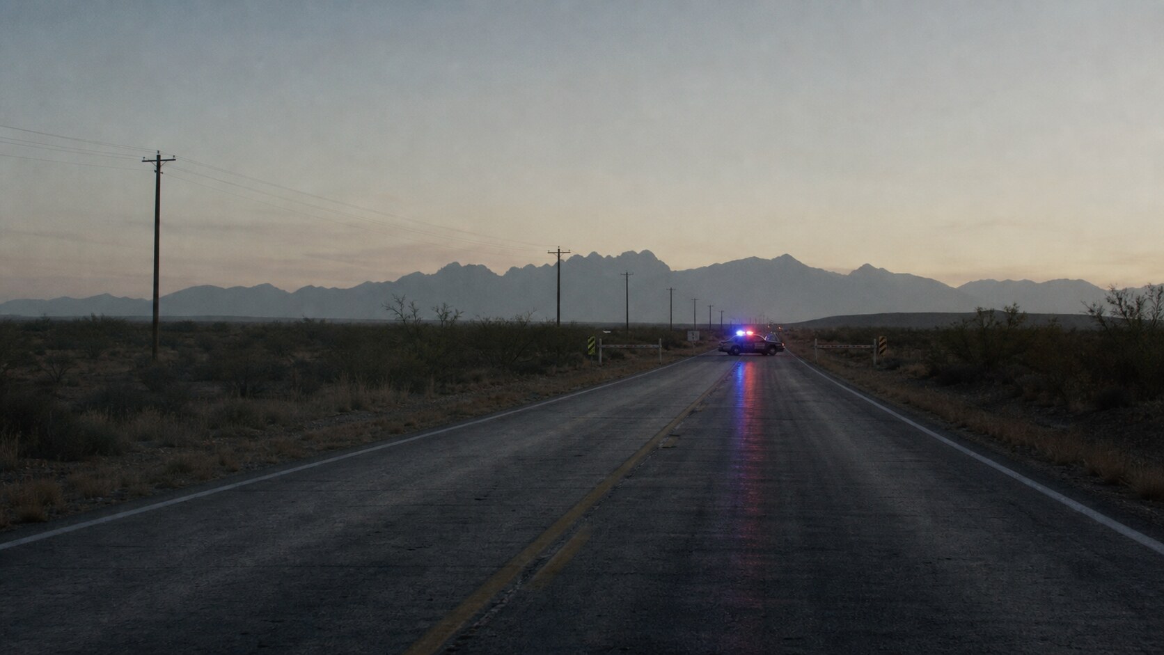 A distant desert highway roadblock evokes the search for the unidentified Las Cruces Bowl gunmen.