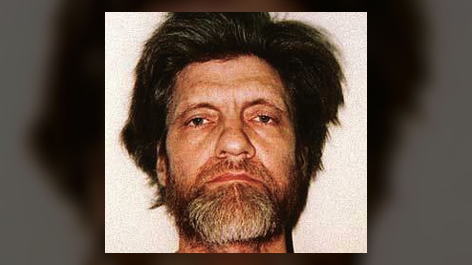 Theodore Kaczynski in an official FBI mugshot, the convicted Unabomber identified after the manifesto publication and linguistic comparison.