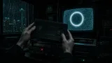 Pale hands hold an unmarked VHS tape above a dual-deck VCR while a glowing ring burns on a CRT screen.
