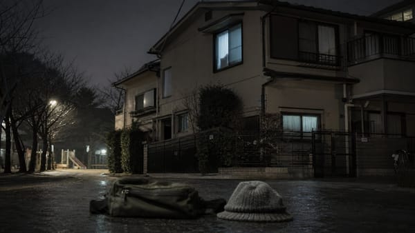 A dark Japanese duplex beside an empty park at night, representing the unsolved Setagaya family murders.